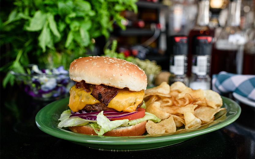 a cheeseburger and chips on a plate