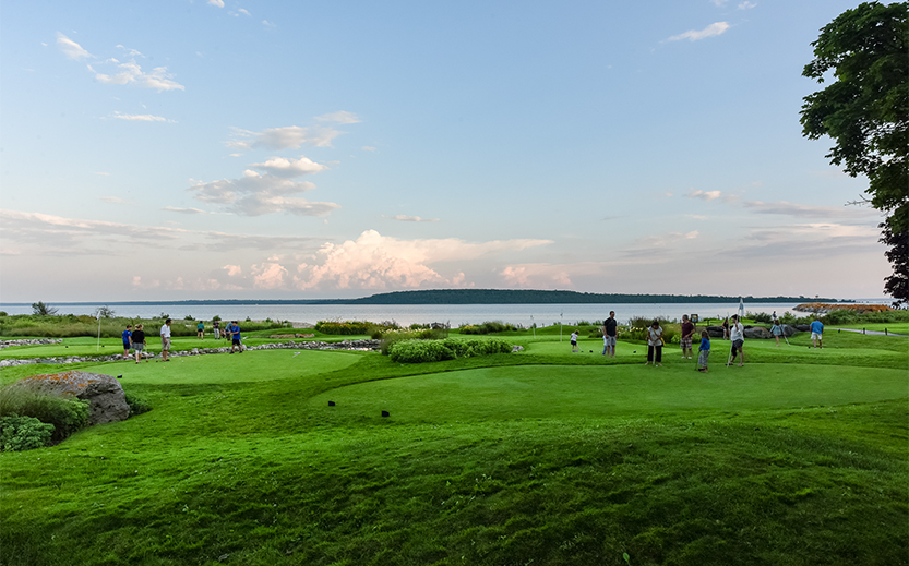 a group of people on a golf course