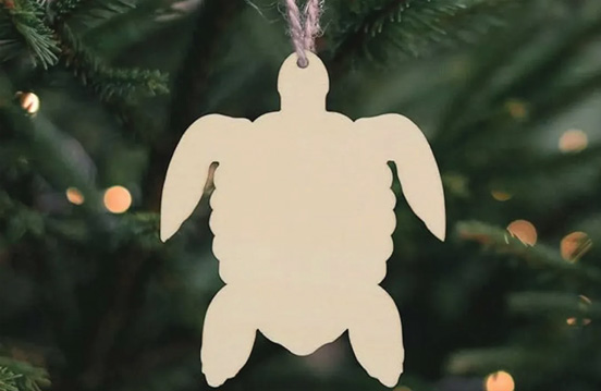 a white turtle shaped ornament from a string