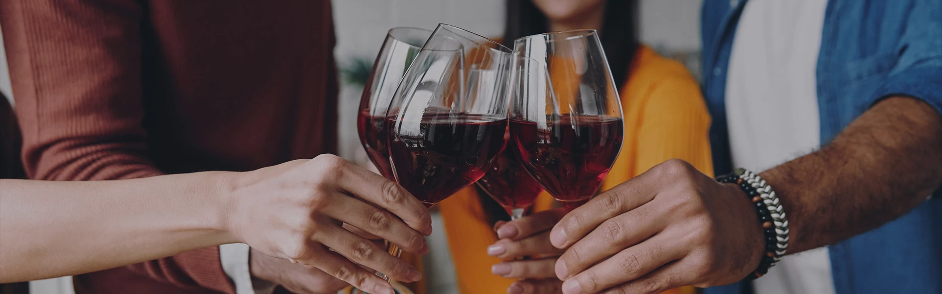 a group of people holding wine glasses