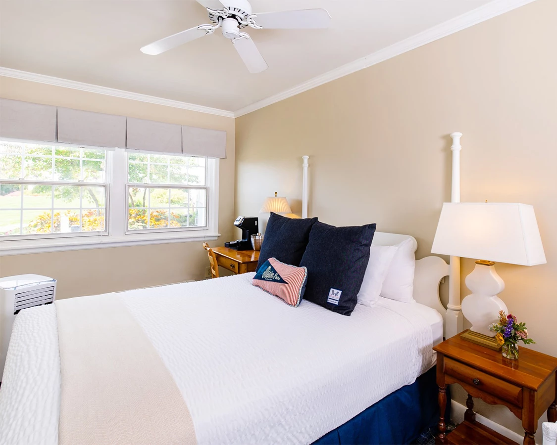 a bed with a lamp and a table