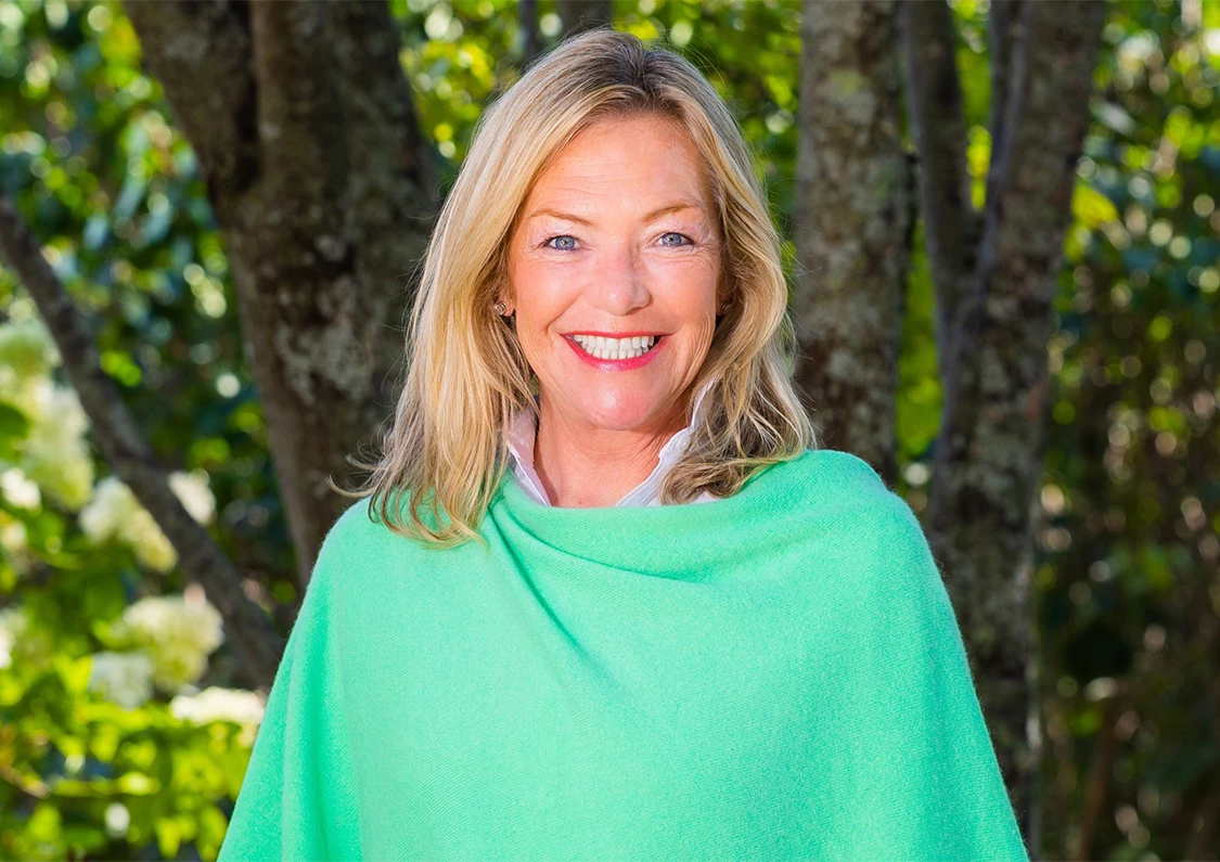 a woman smiling in a green blanket