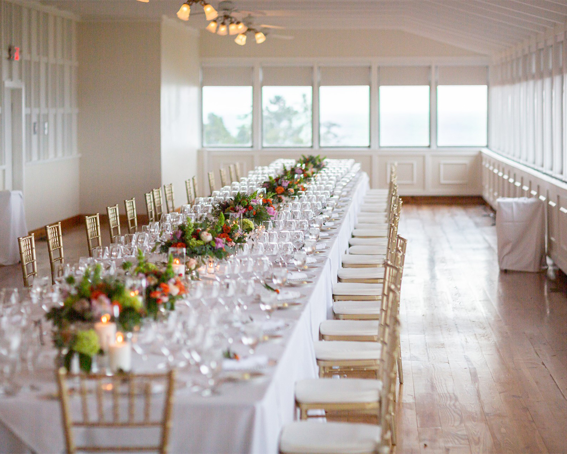 a long table with white tablecloths and flowers