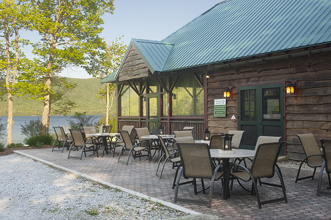 a patio with chairs and tables outside of a building
