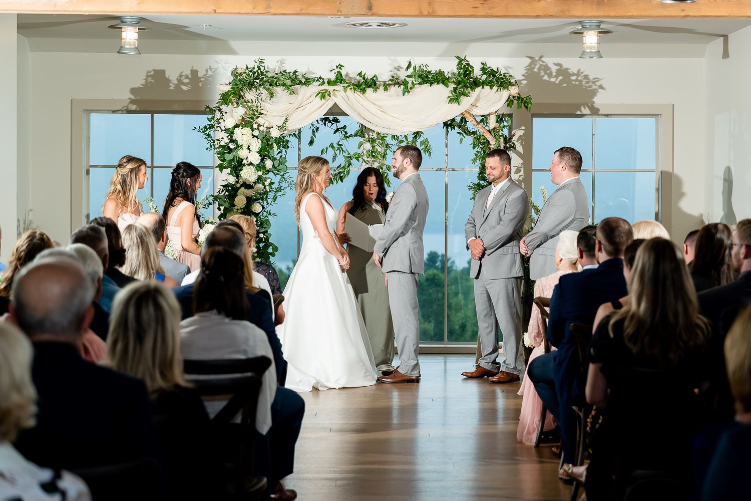 a group of people standing in front of a wedding ceremony