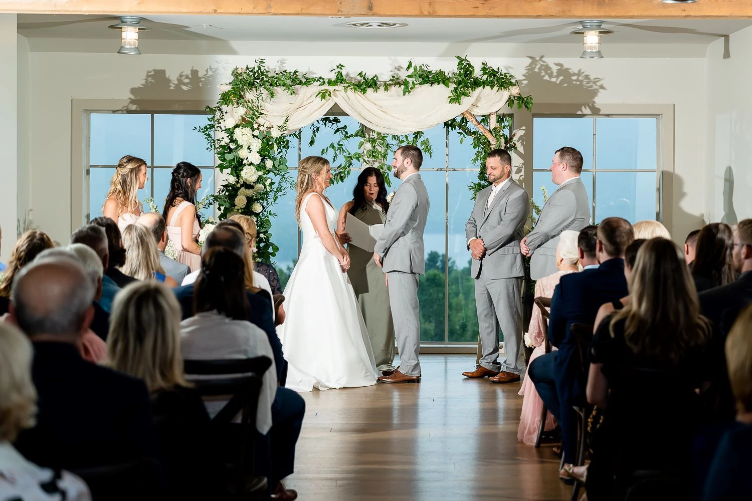 a group of people standing in front of a wedding ceremony