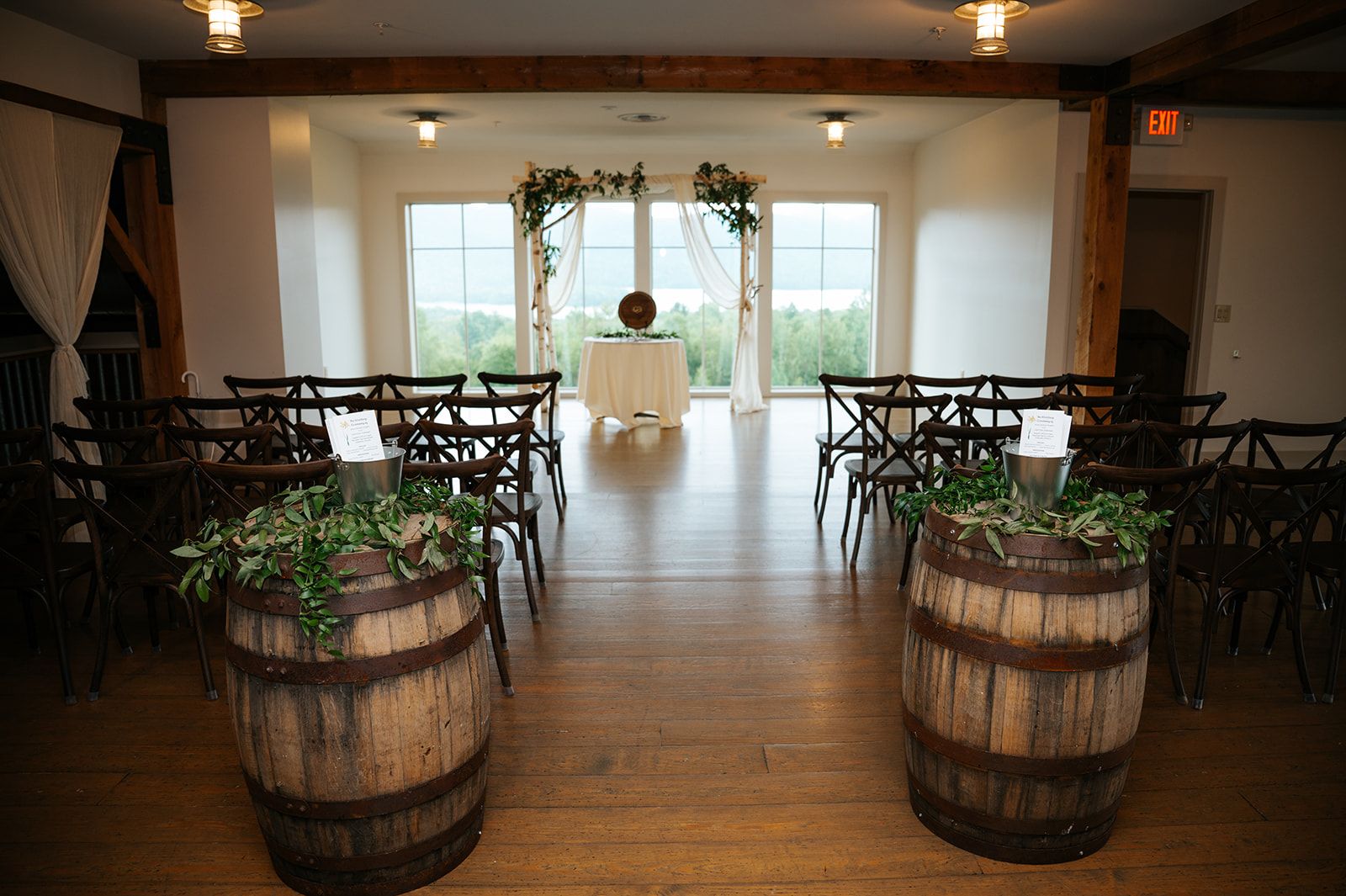 a room with barrels and chairs by Juniper Studios