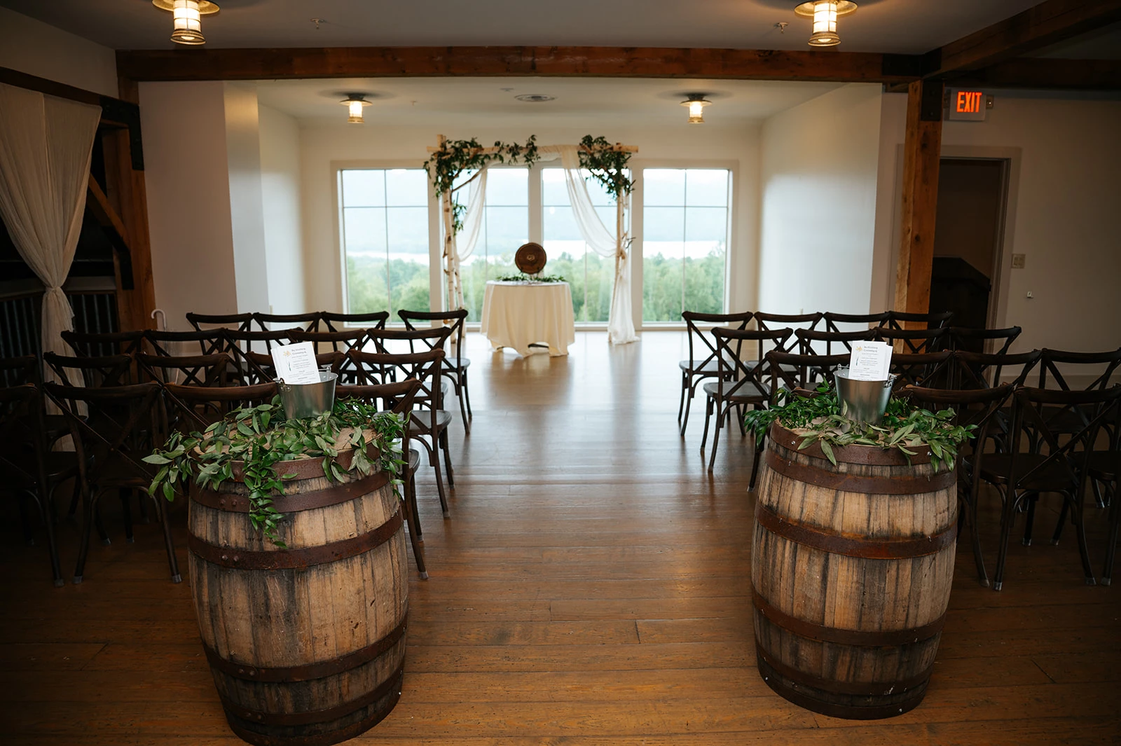 a room with barrels and chairs by Juniper Studios