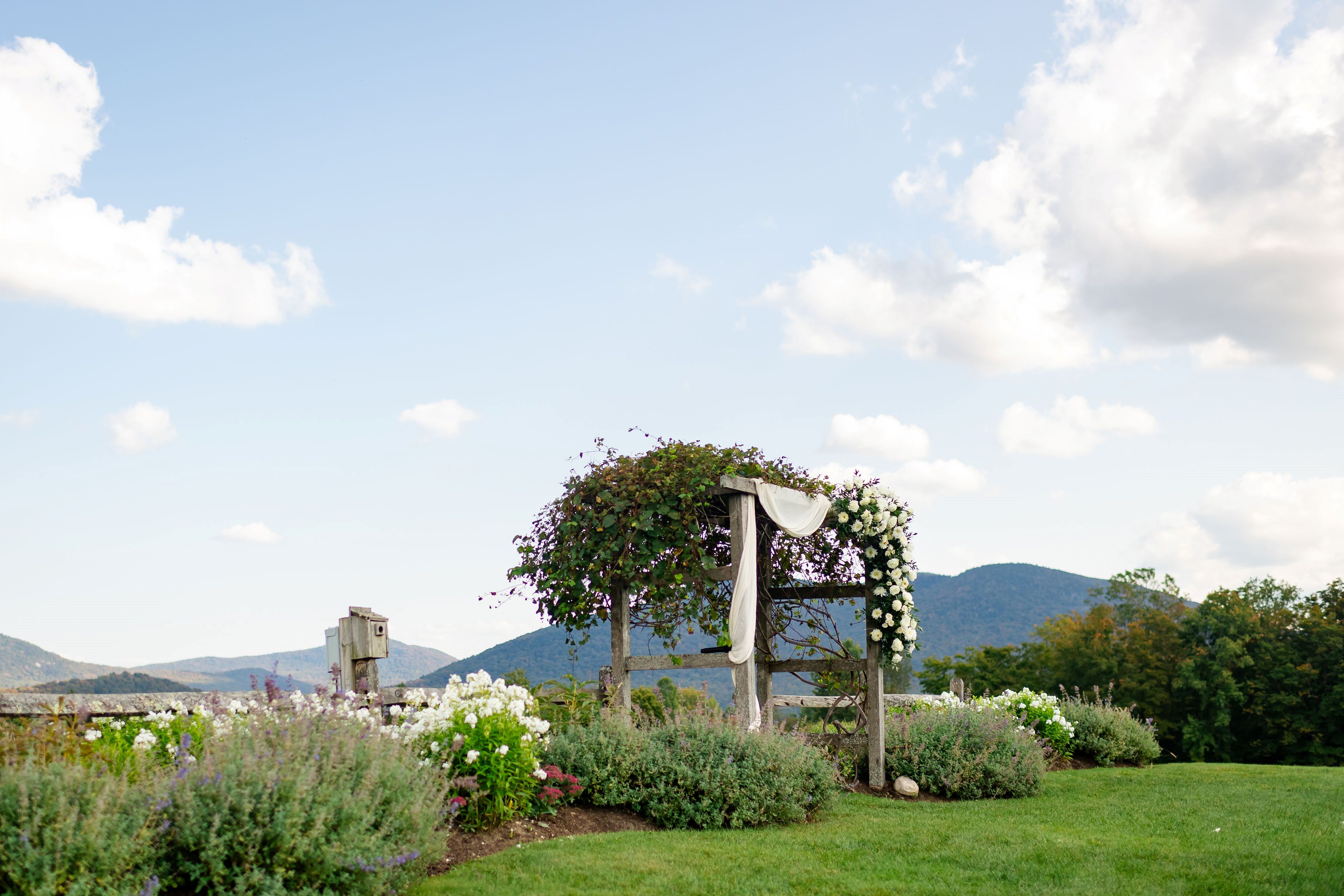 a wooden structure with flowers on it