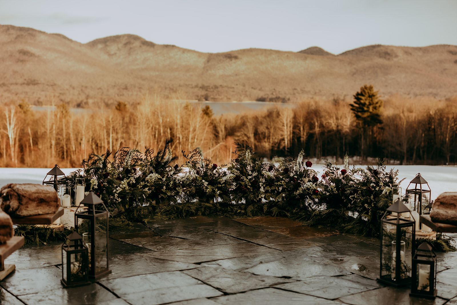 a stone patio with flowers and candles on it