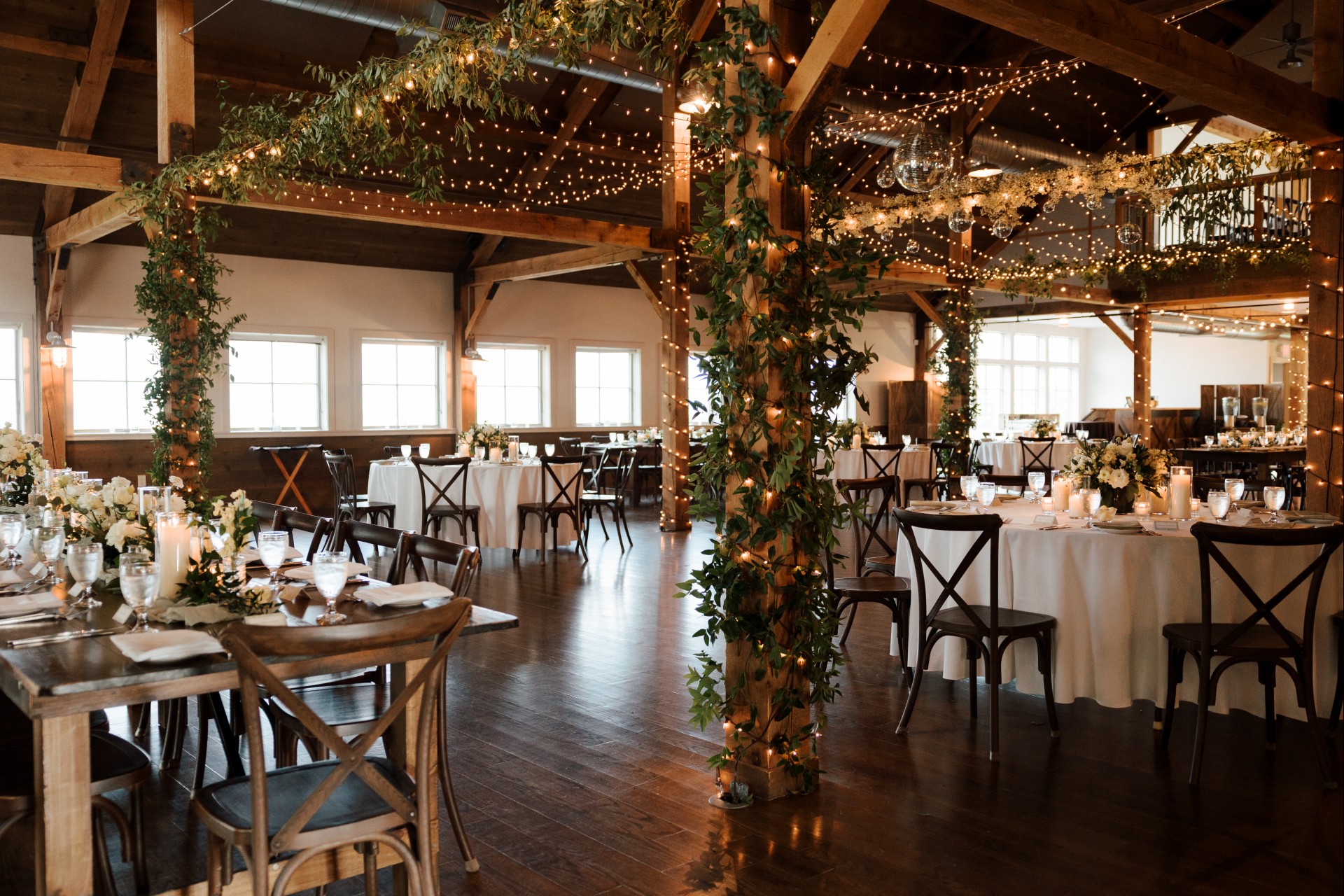 a room with tables and chairs and lights photographed by Gold Wing Photography