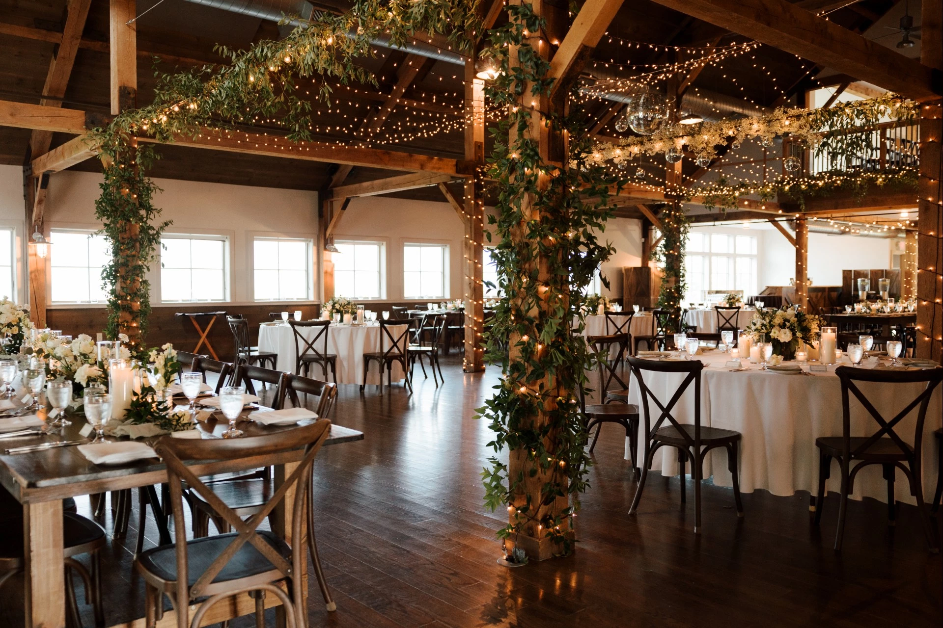 a room with tables and chairs and lights photographed by Gold Wing Photography