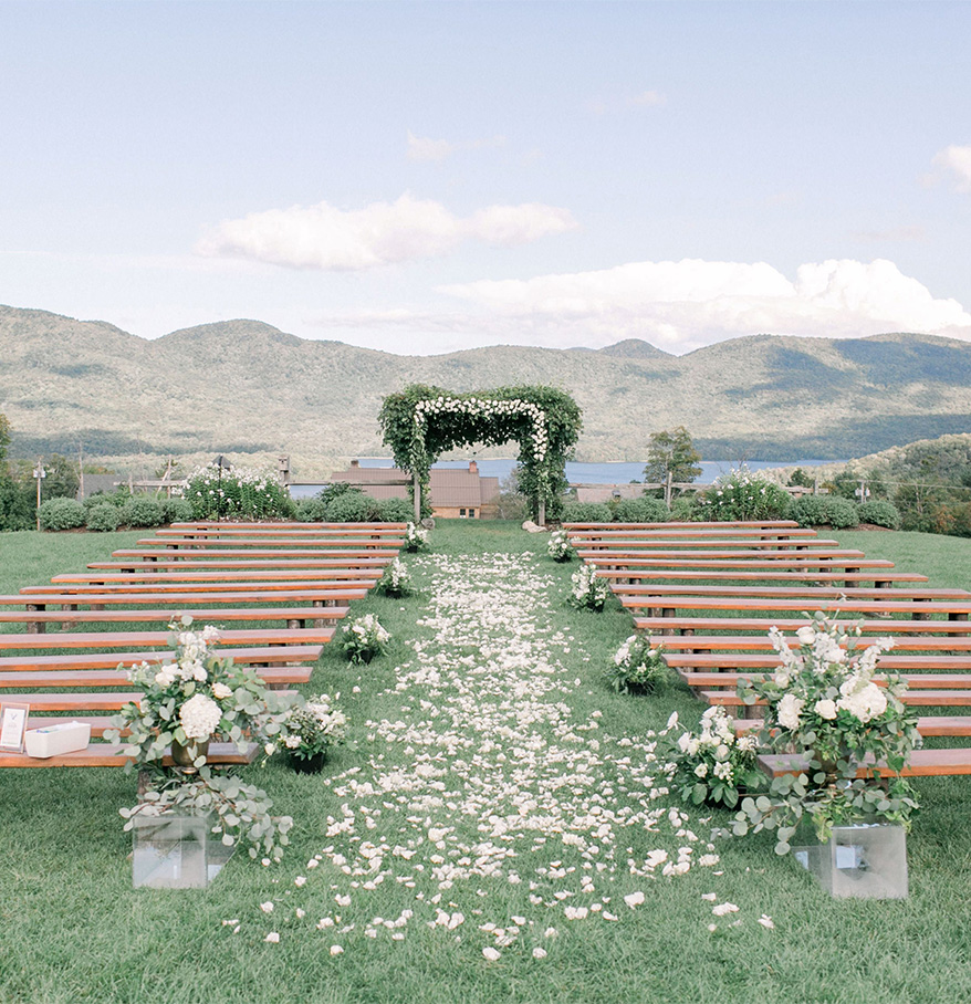 a wedding ceremony with benches and flowers