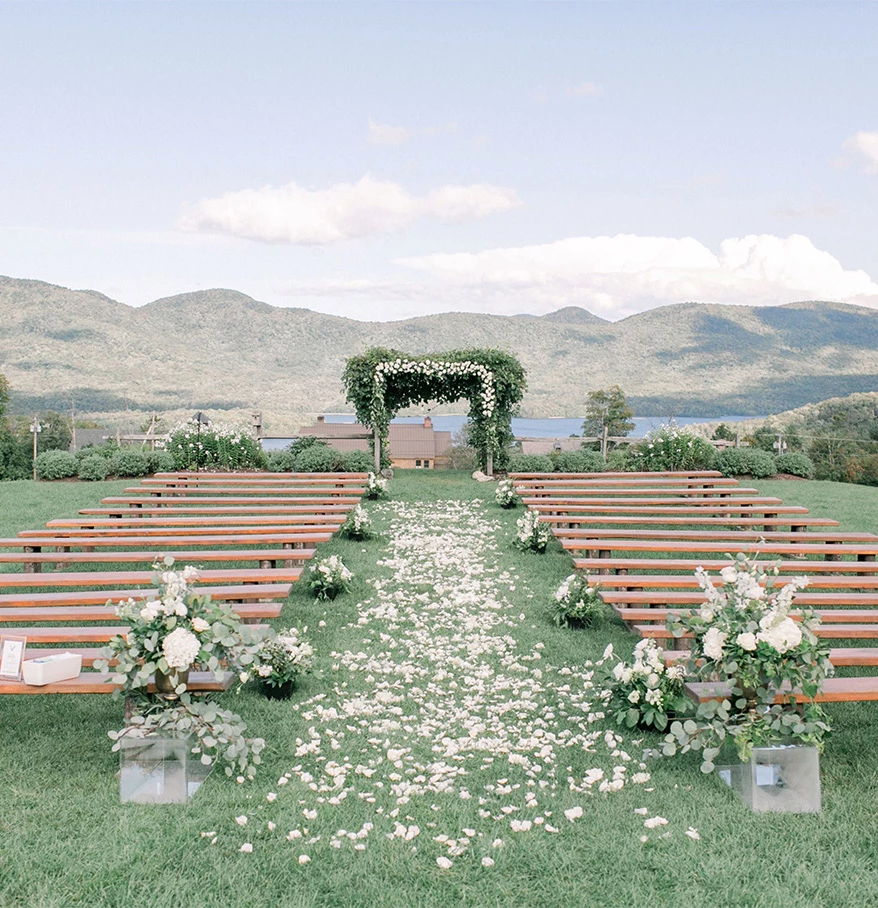 a wedding ceremony with benches and flowers