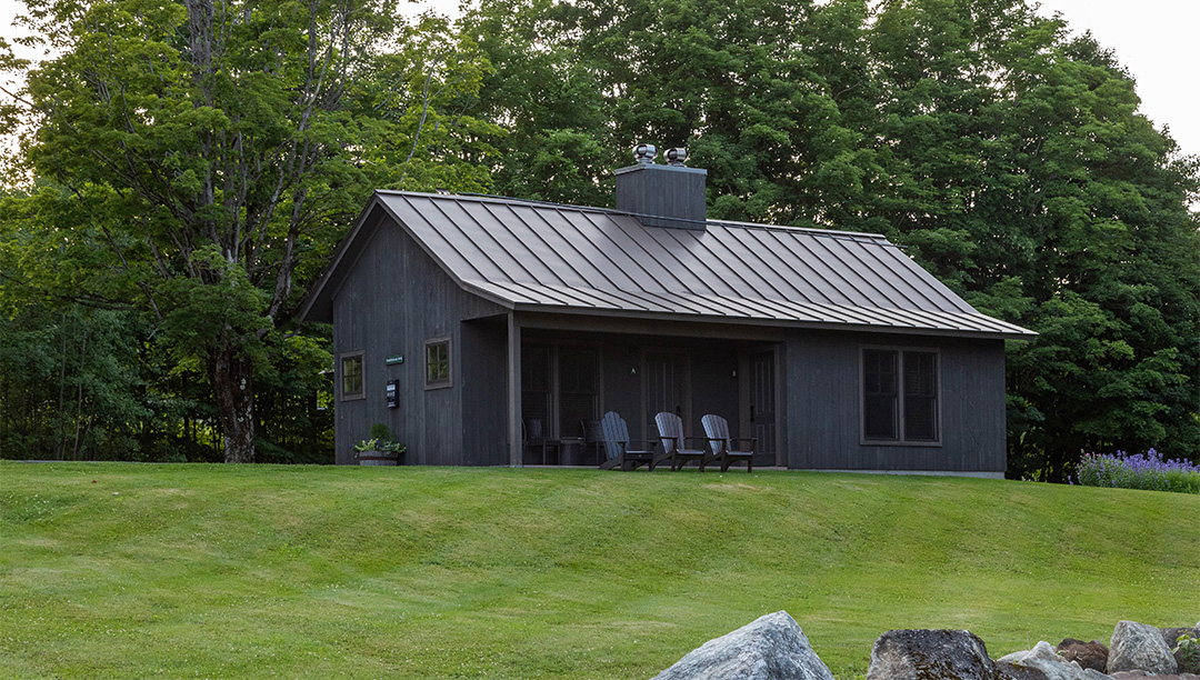 a house with lawn chairs on the side