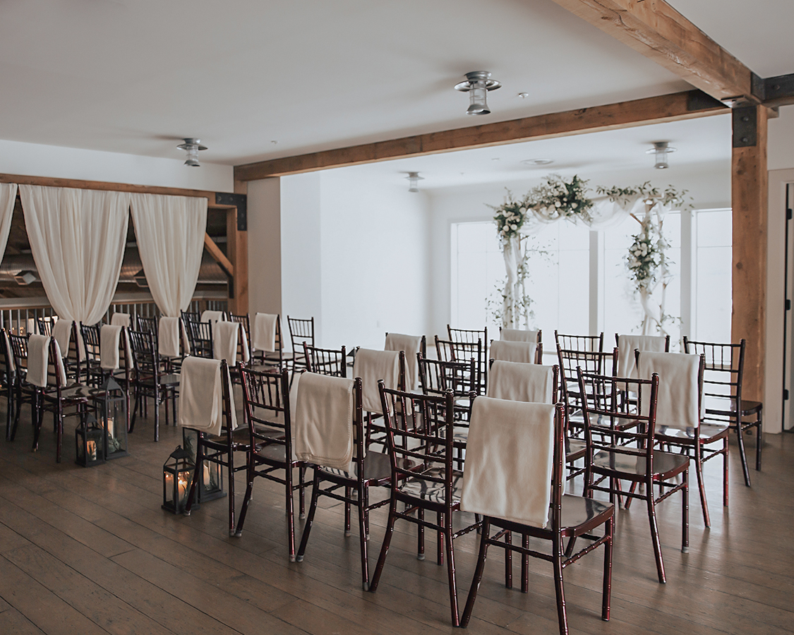 a room with chairs and a white arch