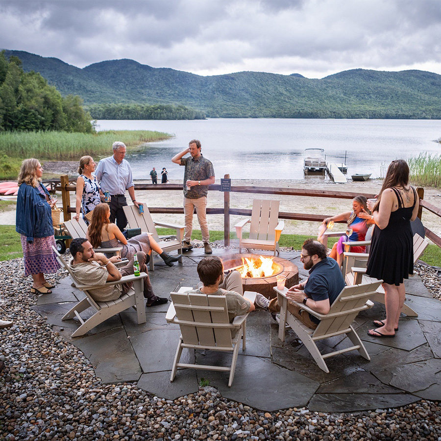 a group of people around a fire pit