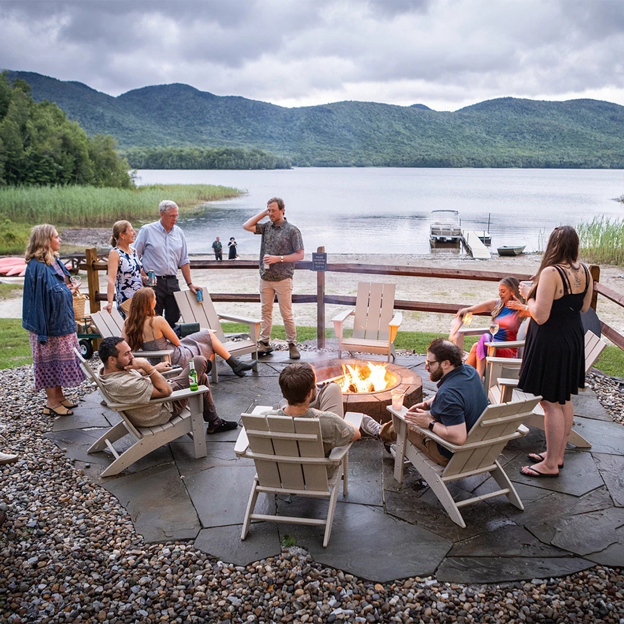 a group of people around a fire pit