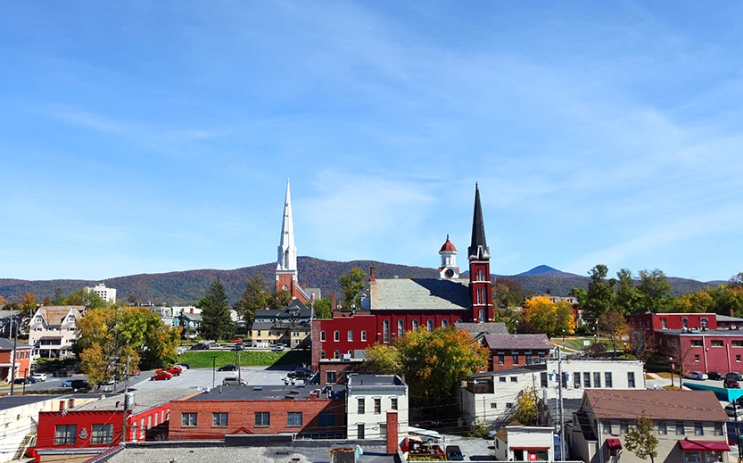 a town with a red building and trees