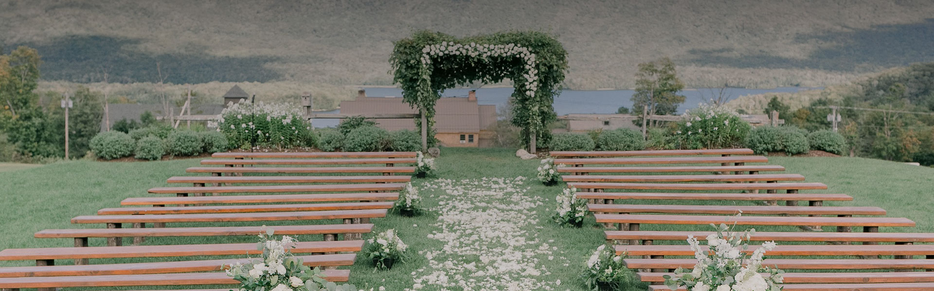 a wedding ceremony with benches and flowers