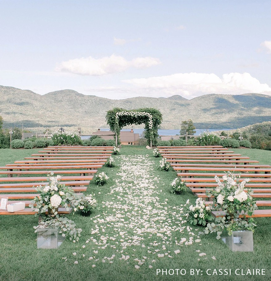 a wedding ceremony with benches and flowers