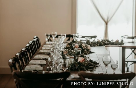 a long table with flowers and glasses