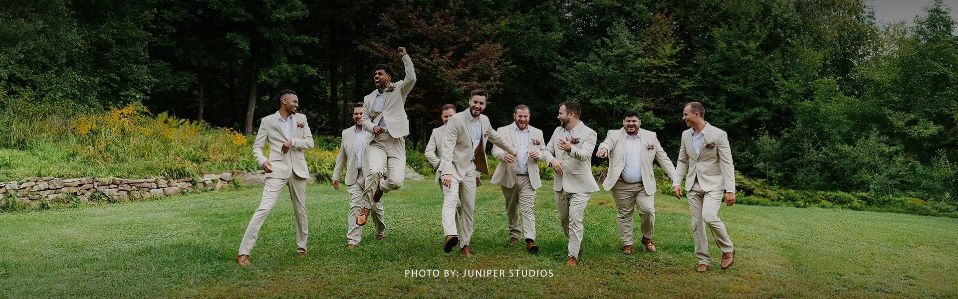 a group of men in suits running in a line