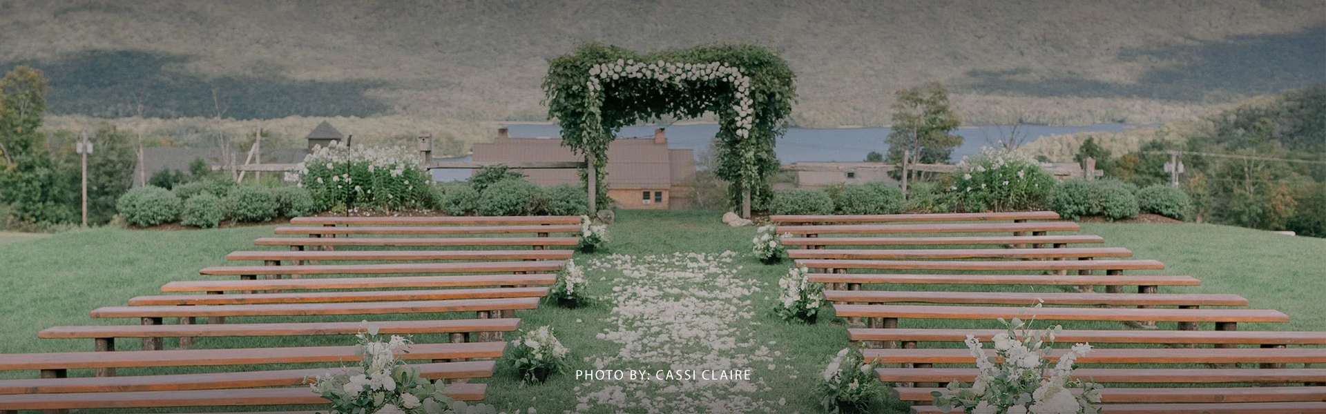 a wedding ceremony with benches and flowers