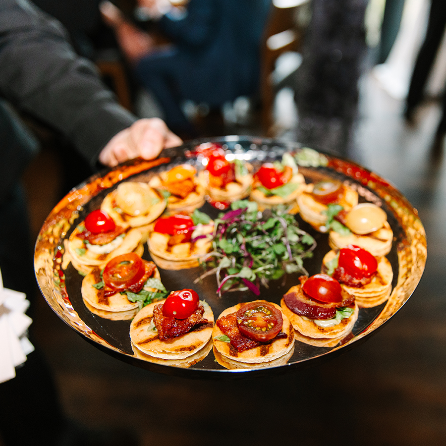 a person holding a tray of food