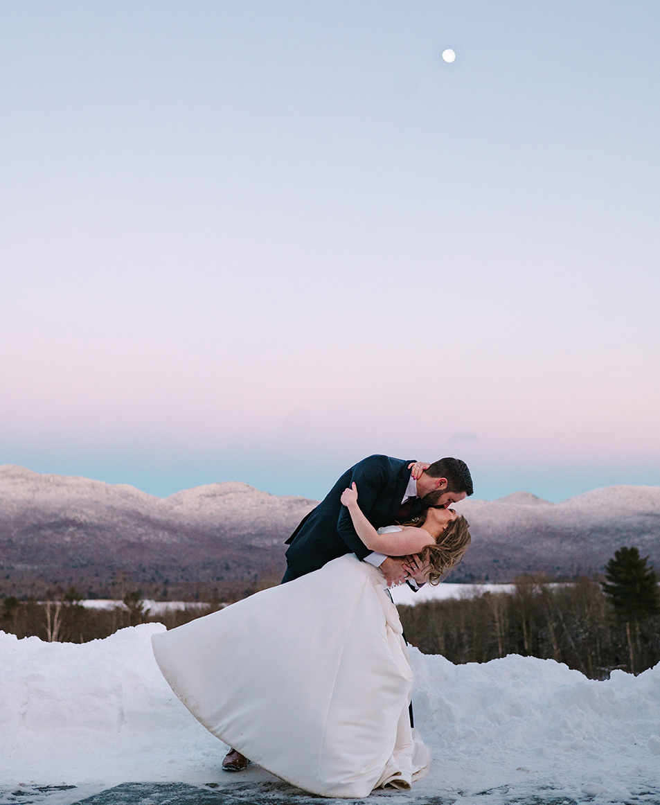 a man and woman kissing in the snow