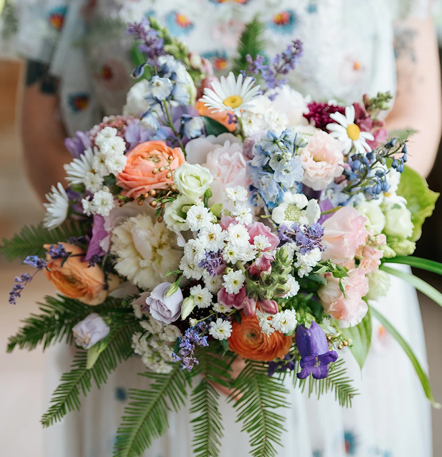 a woman holding a bouquet of flowers