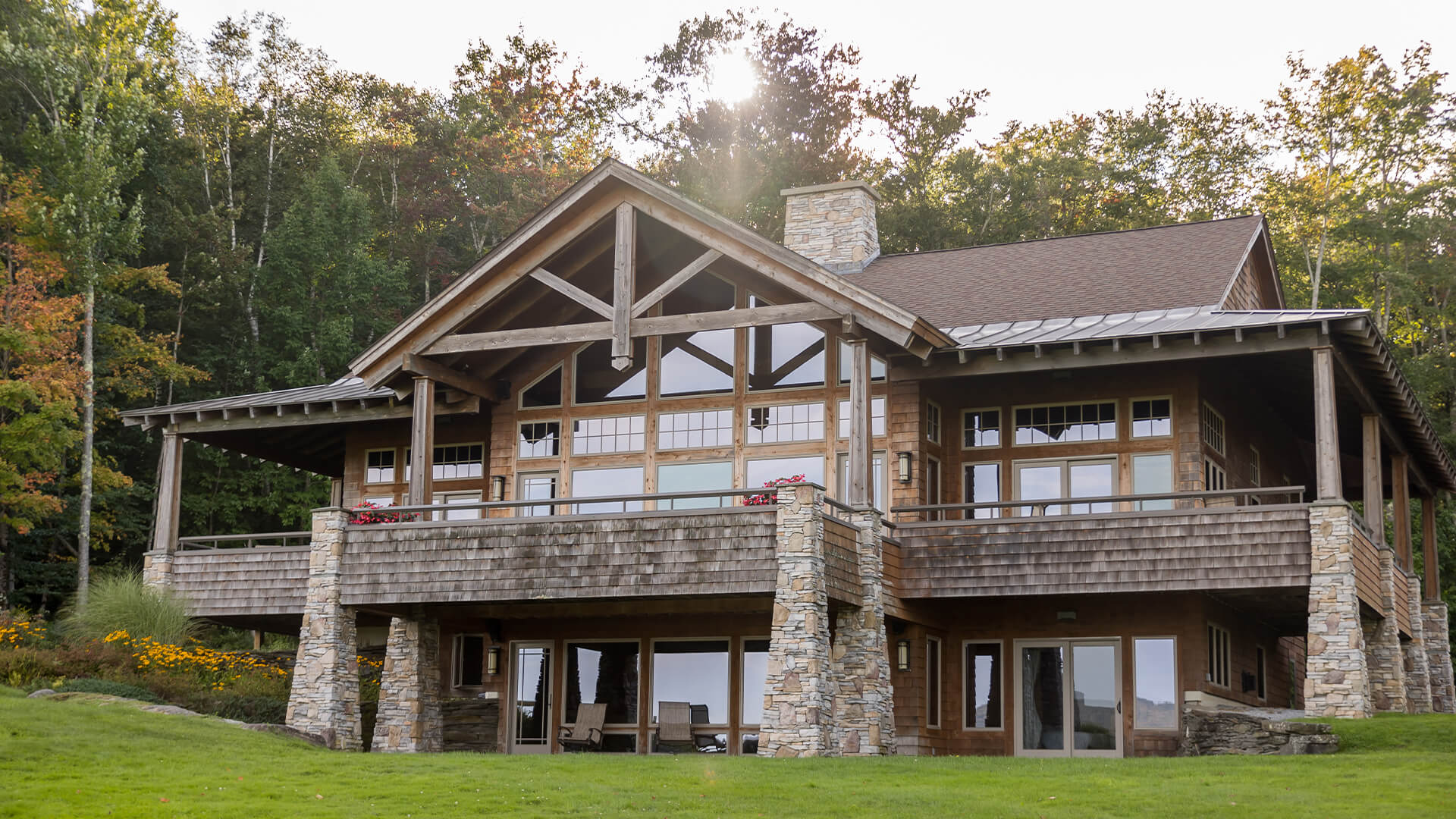 a large house with a stone wall and a stone porch