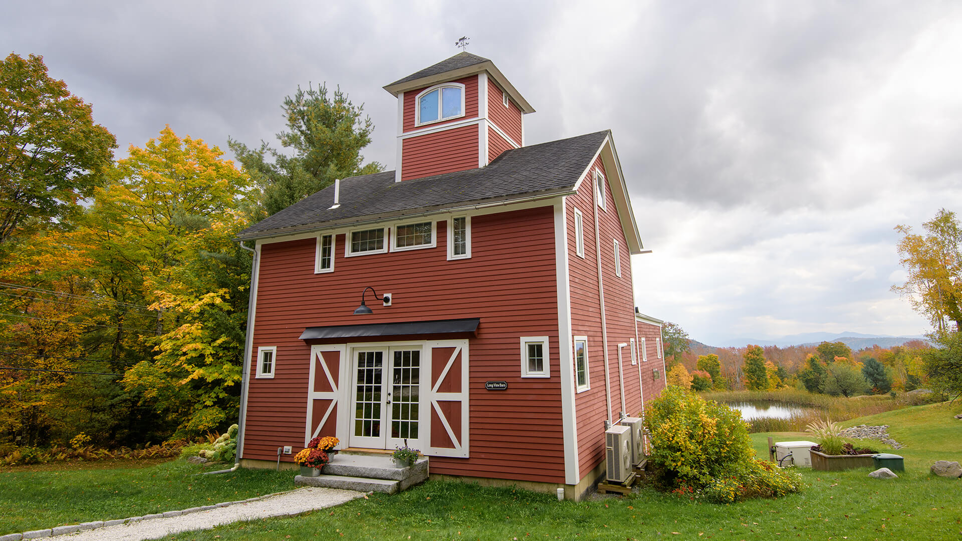 a red barn with Two Harbors Light on the side