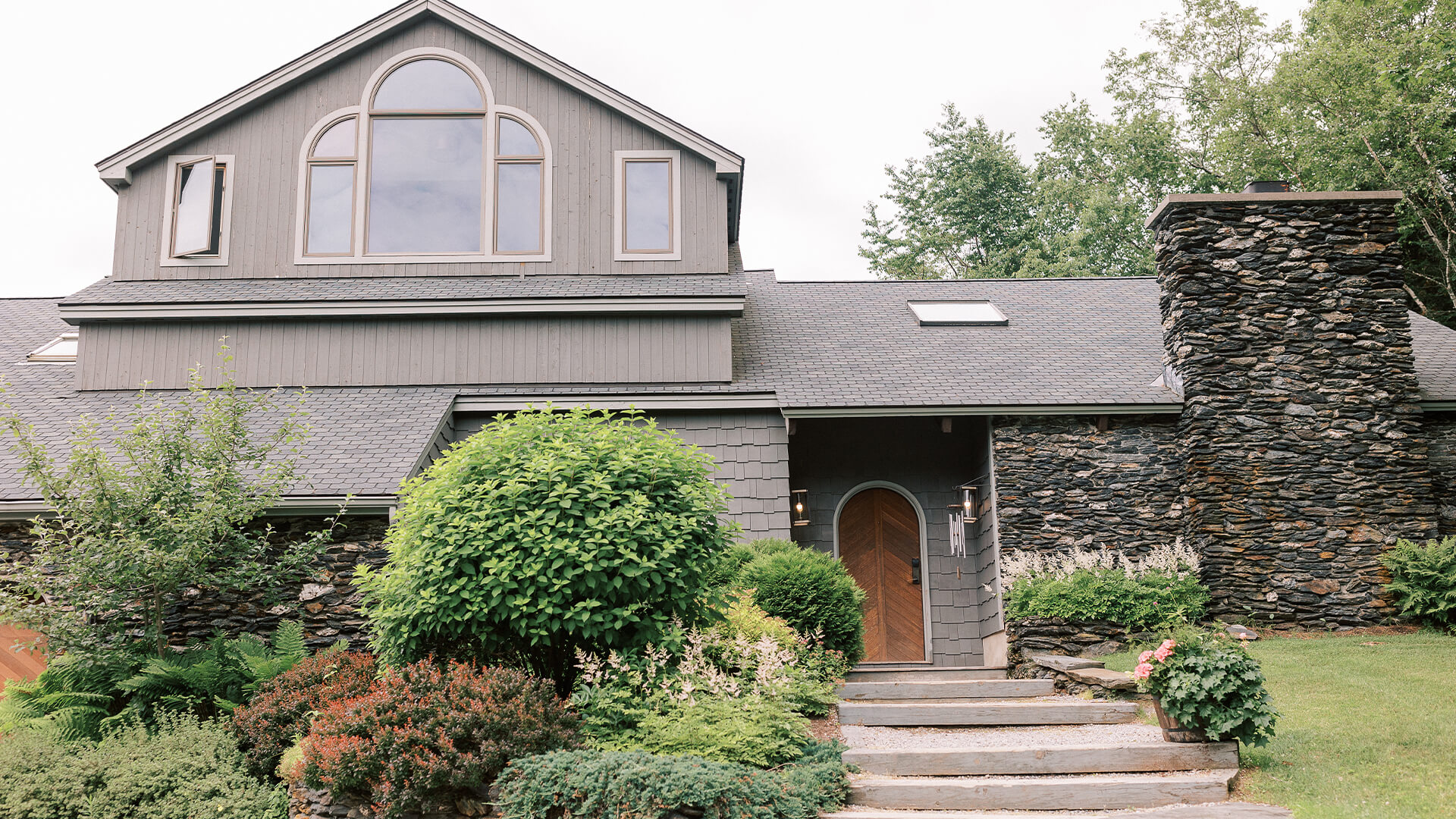 a house with a stone wall and a stone wall and a stone wall