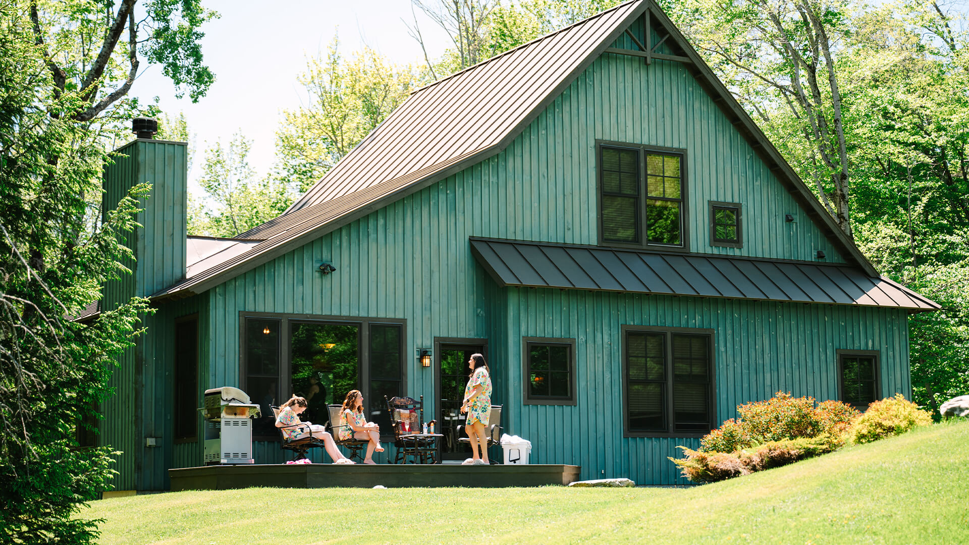 a group of women sitting outside a house