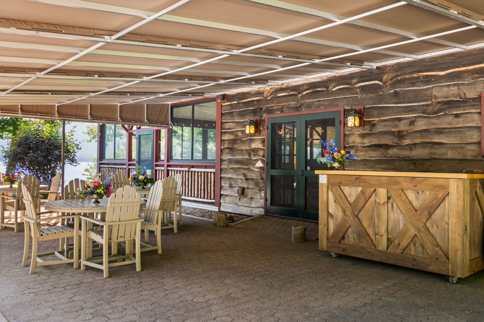 a wooden building with a table and chairs