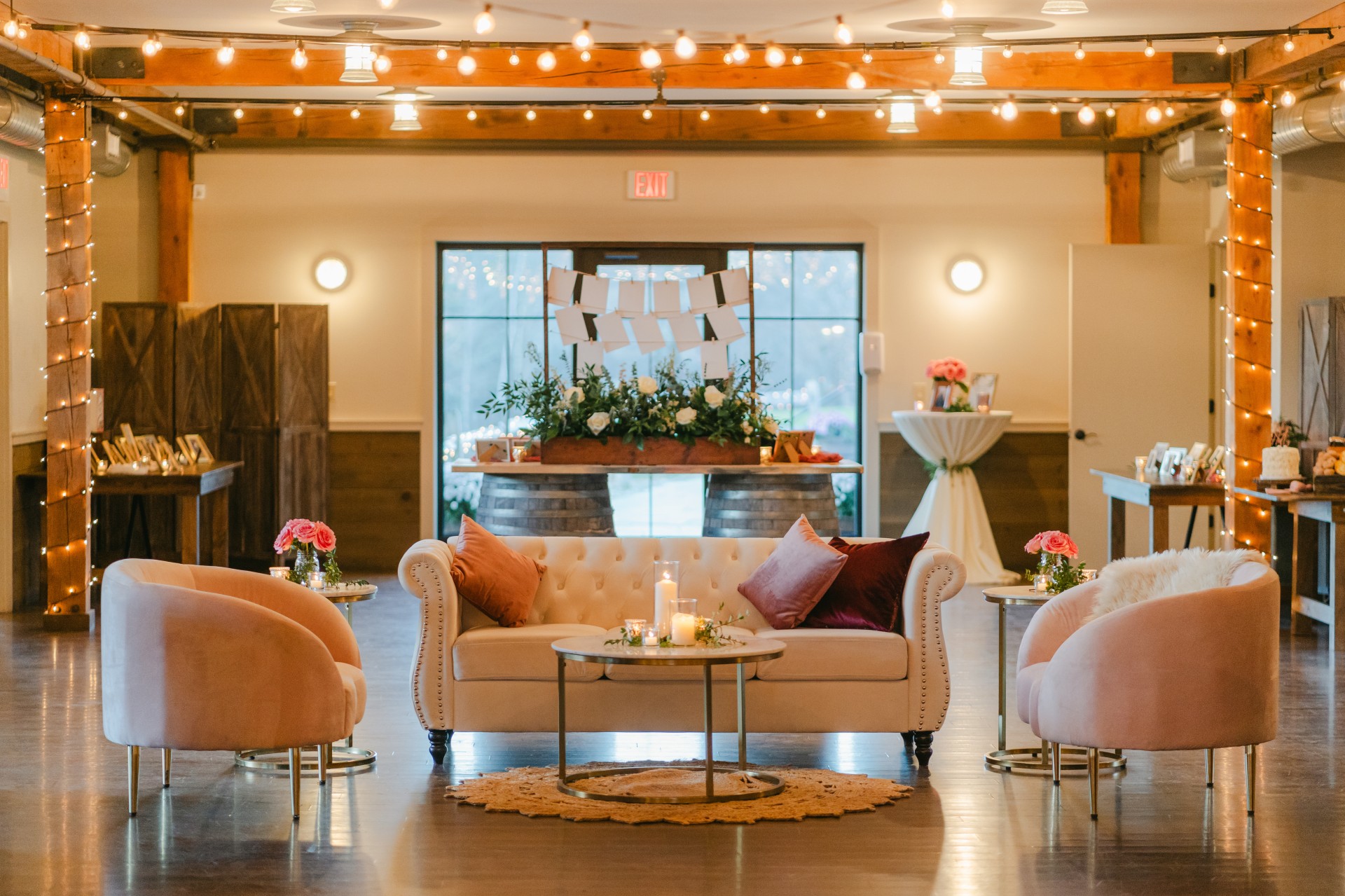 a room with a couch and chairs by Cania Photography