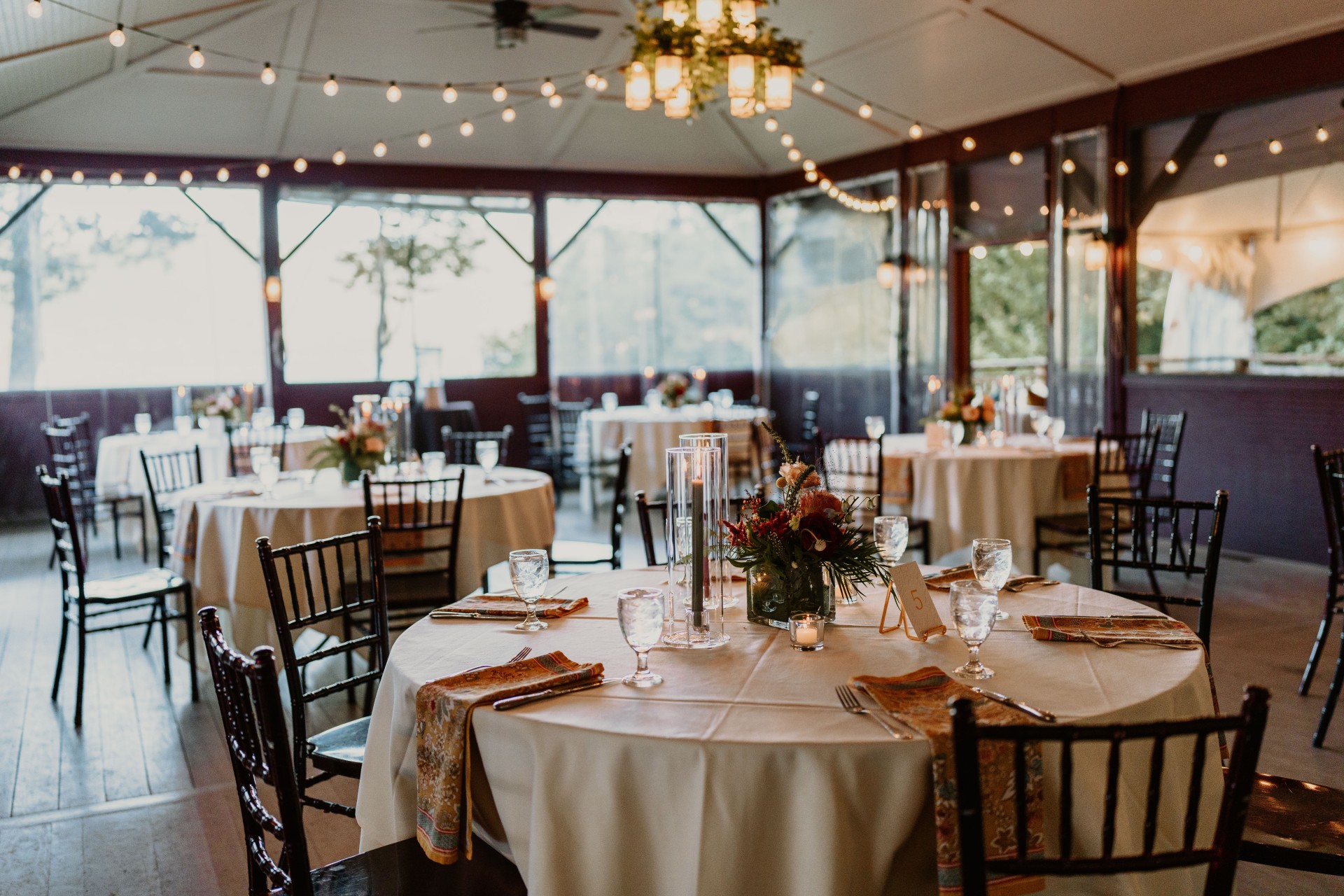 tables set for beach pavilion welcome party by Tree Films Creative