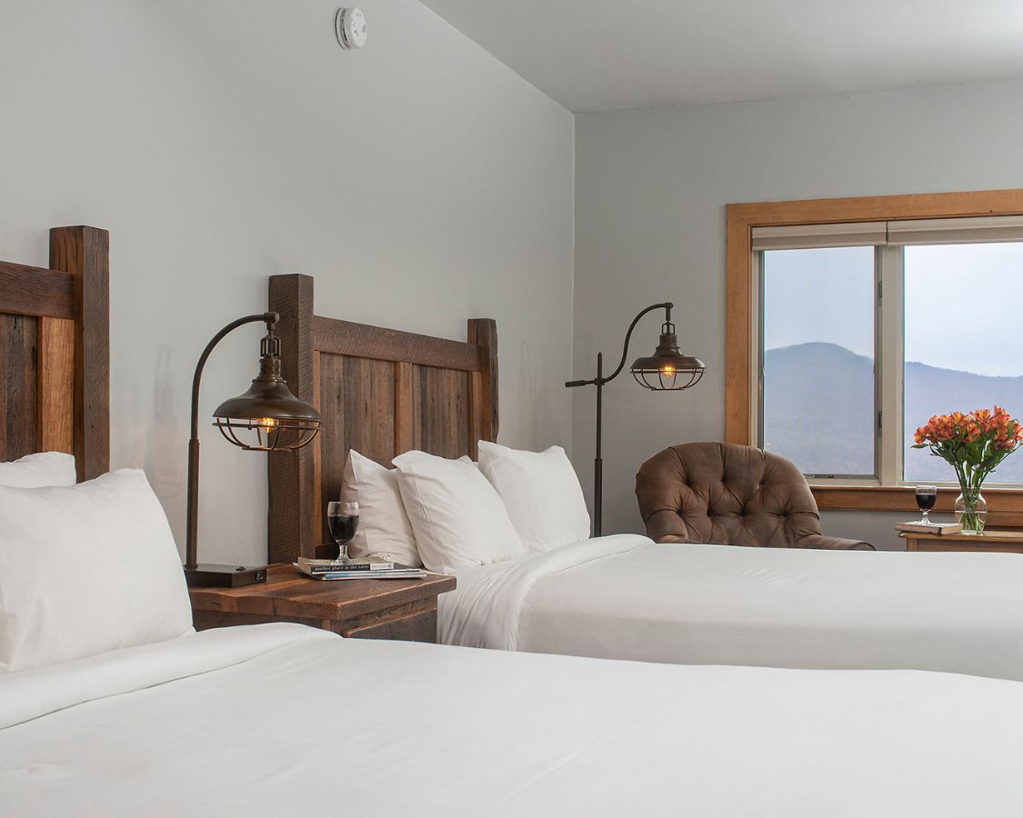 a room with two beds and a window