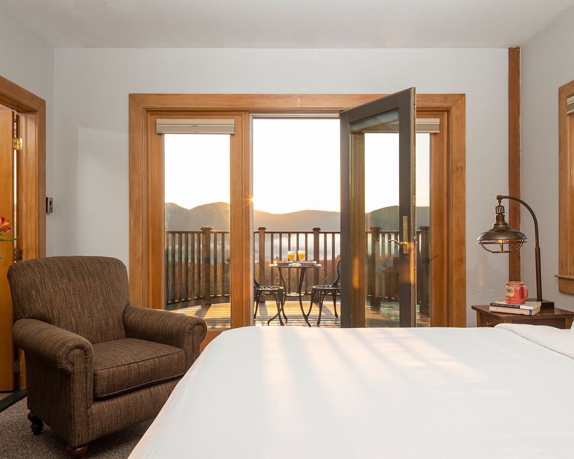 a bedroom with a bed and a chair and a table