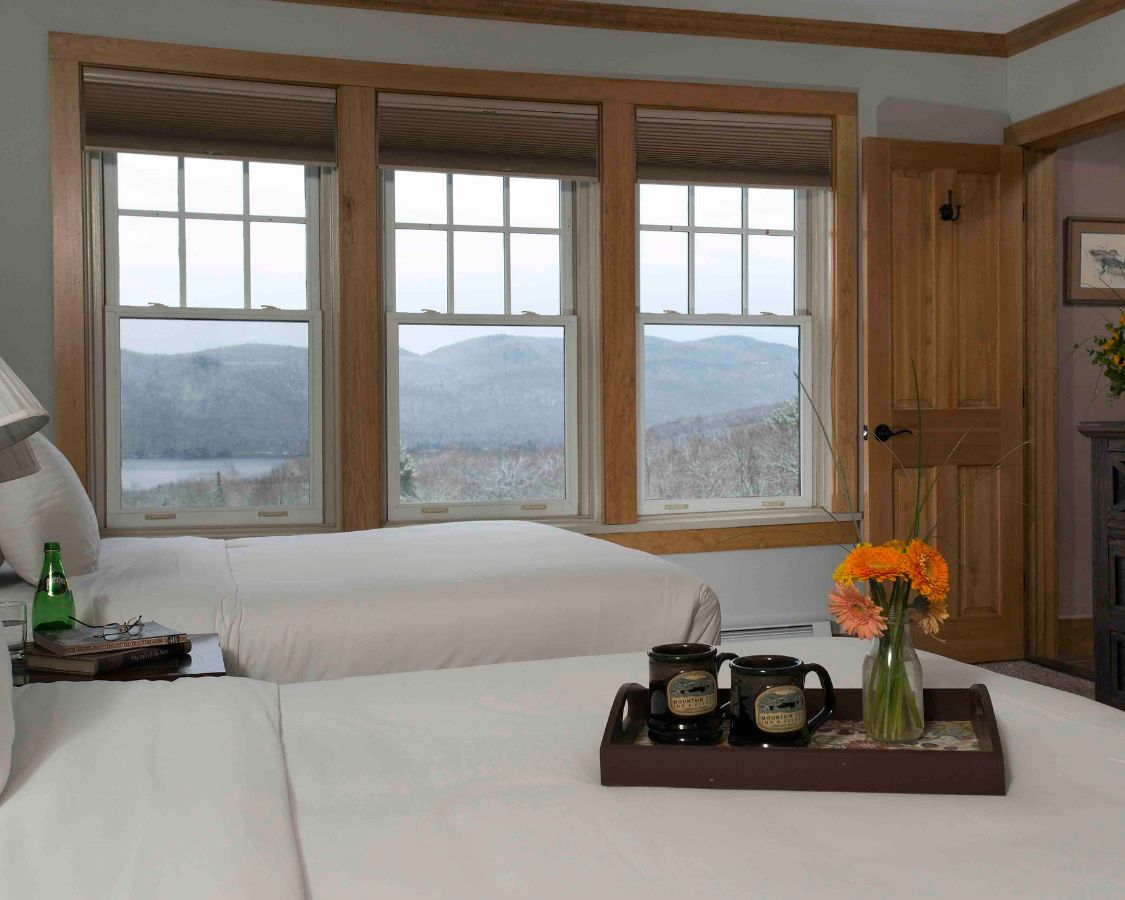 a room with two beds and a tray of flowers