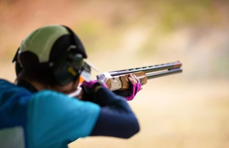 a person aiming a gun
