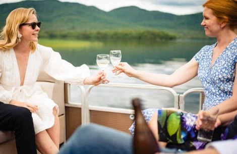 a group of women holding wine glasses on a boat