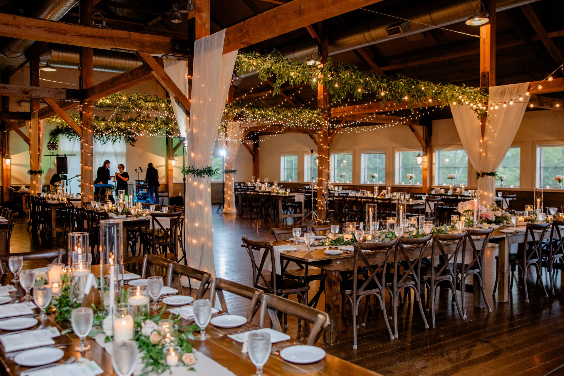 a room with tables and chairs and candles by Anne Mientka