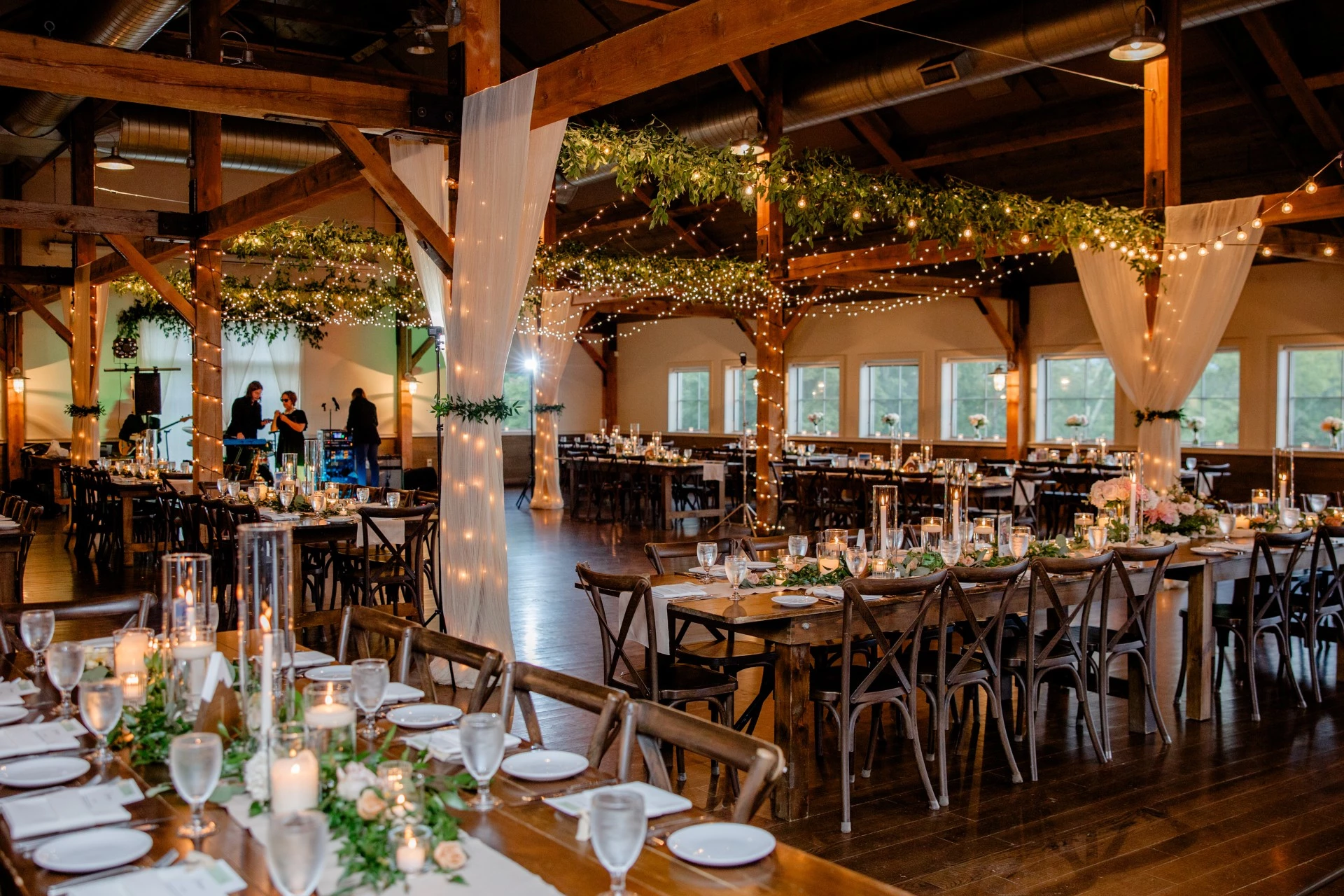 a room with tables and chairs and candles by Anne Mientka