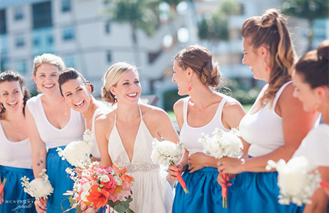 a group of women wearing white and blue dresses