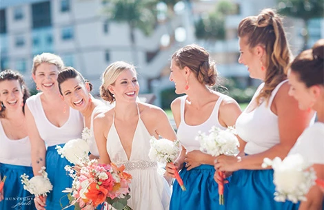 a group of women wearing white and blue dresses
