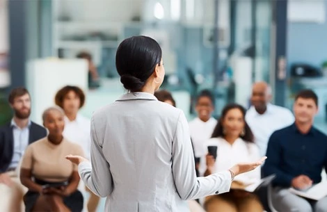 a woman standing in front of a group of people