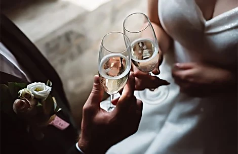 a man and woman holding champagne glasses