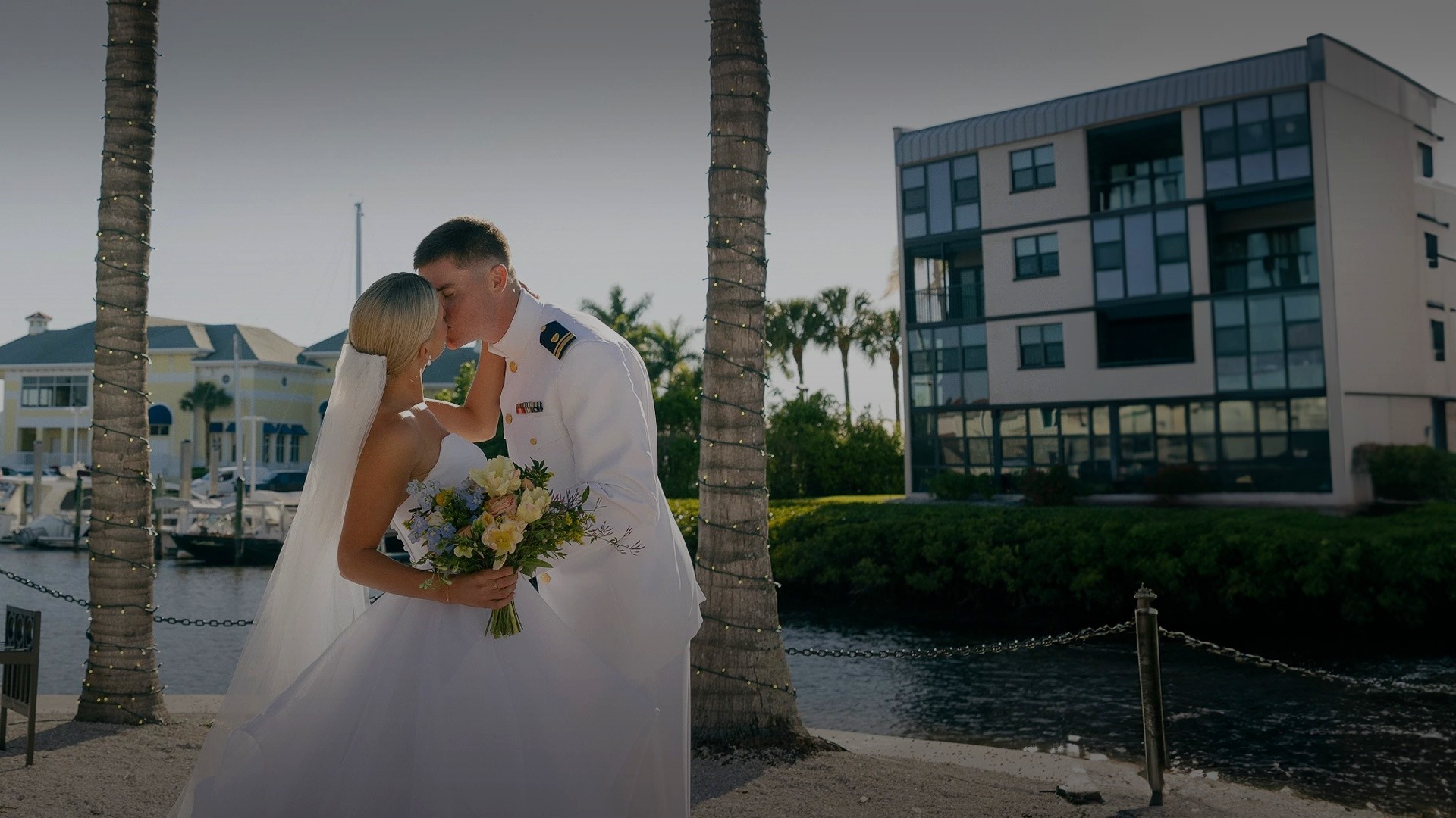 a man and woman kissing in front of a building